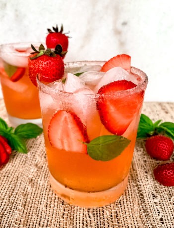 A vodka and tonic cocktail made with ripe strawberries and garden fresh basil.