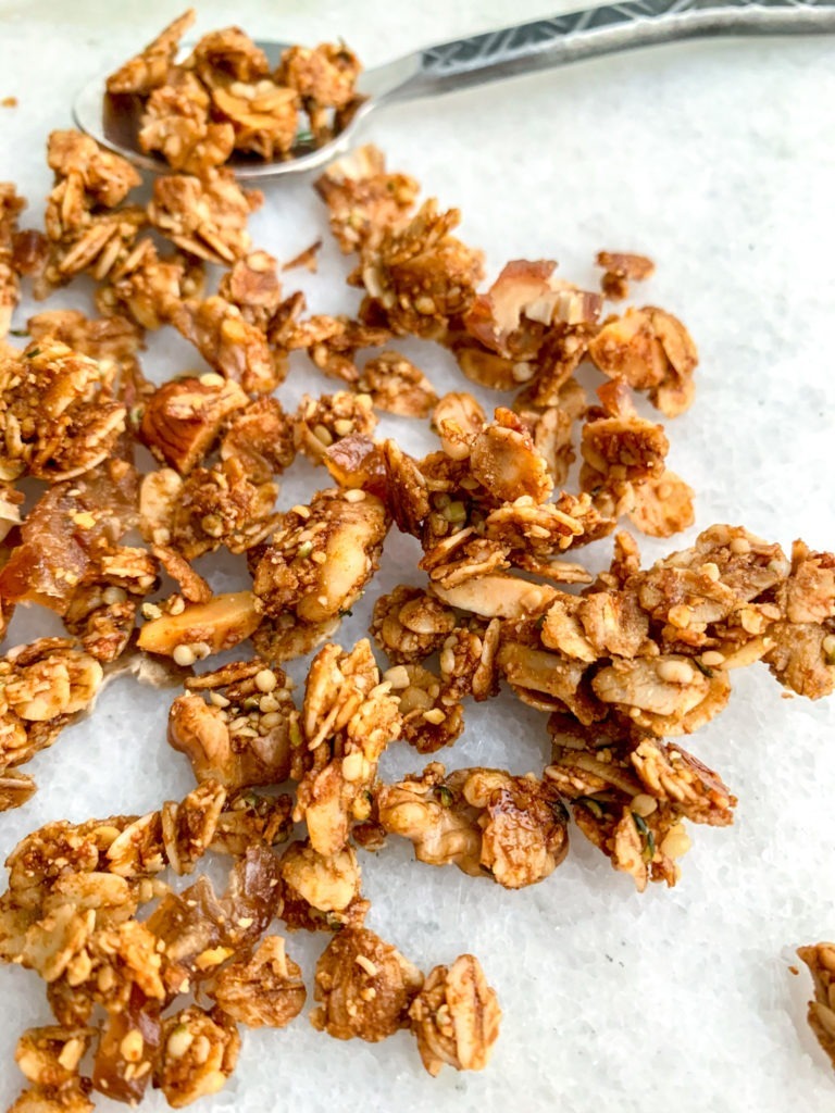 Crunchy bits of homemade vegan granola made with nuts, seeds, and dates.